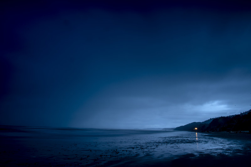 Minimalist long exposure blue hour at Kalaloch Beach with lone distant light